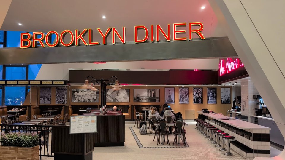 Airport diner interior with tables and bar seating.